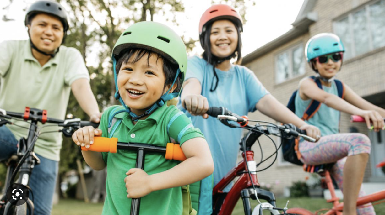 Family cycling together outdoors